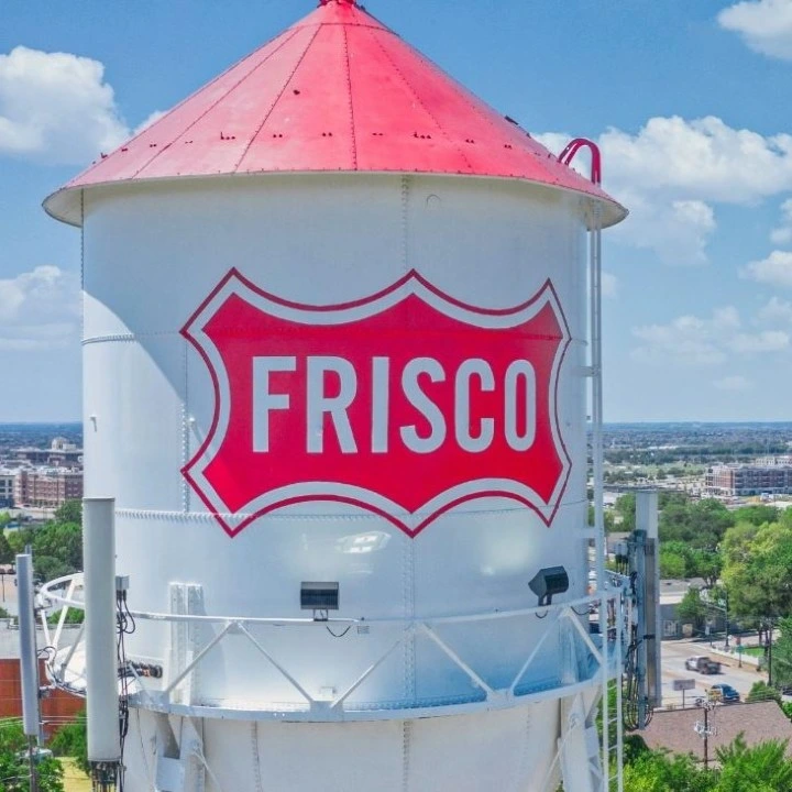 Frisco, TX water tower painted with the city's red shield logo
